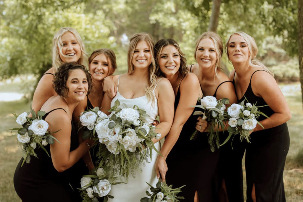 Bridesmaids in Black With White Flowers