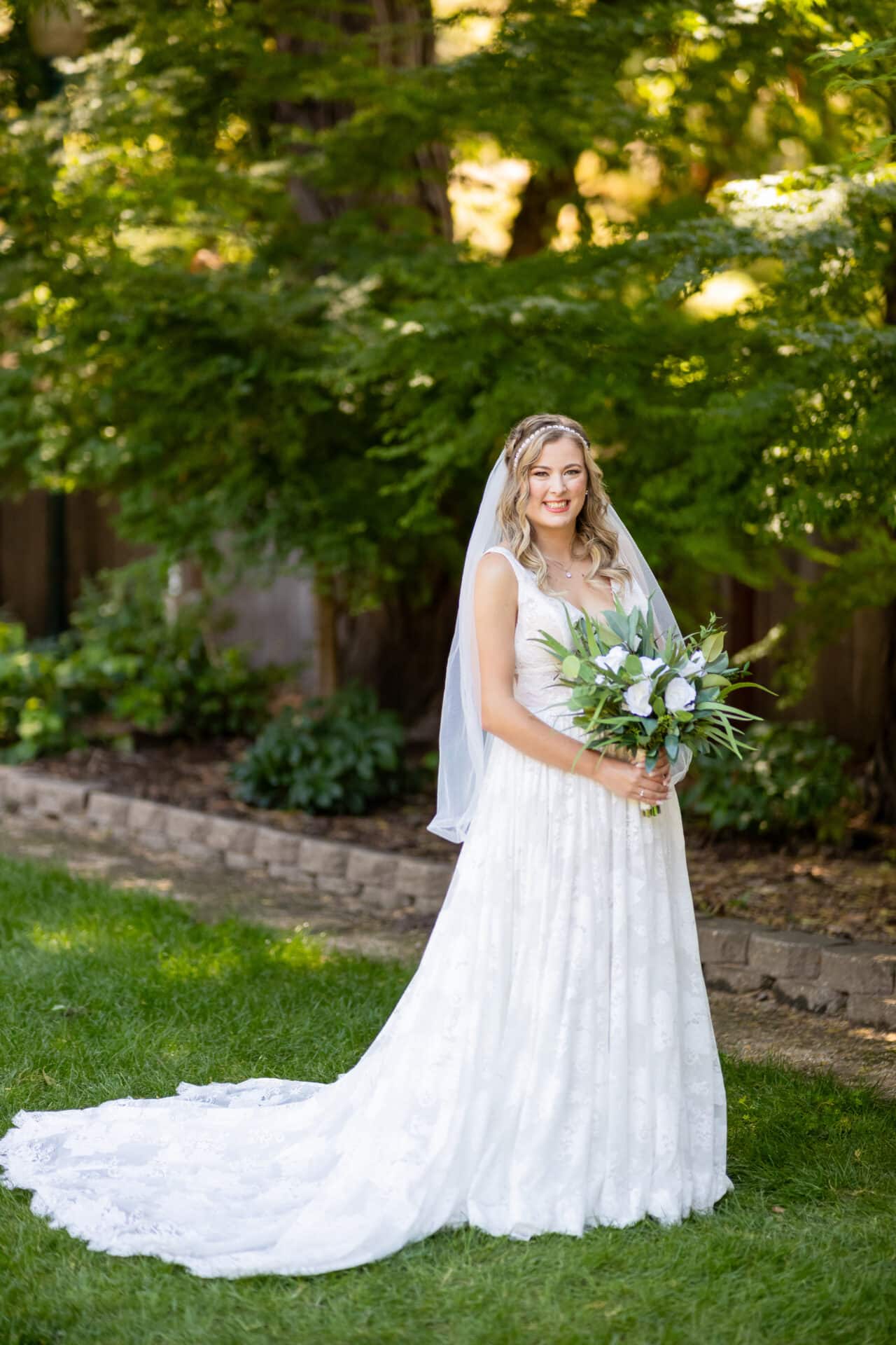 Bride with Greenery and White Rosebud Bouquet