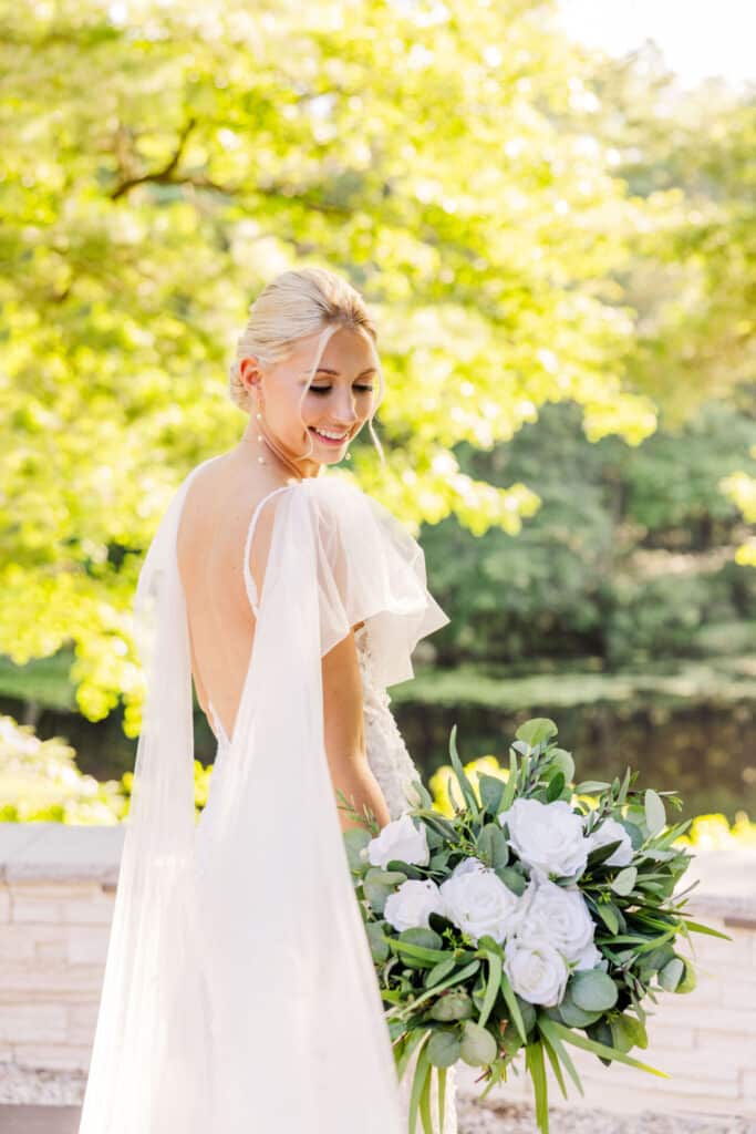 Bride Hannah posing with White Bouquet on Wedding Day