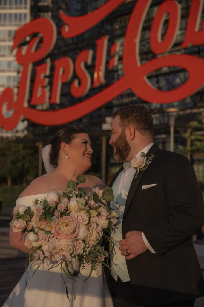 Claire + AJ New York Wedding in front of Pepsi Sign