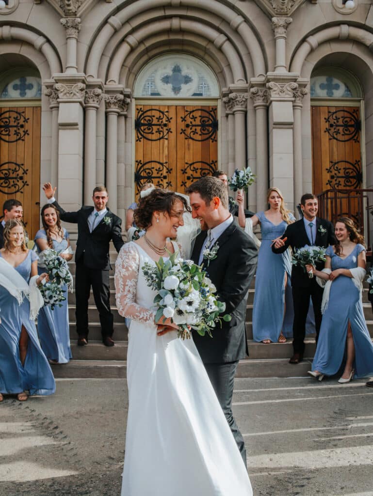 Couple Posing with Jannie Collection and Wedding Party